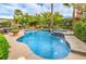 Sparkling pool with a built-in spa, rock features, and meticulously maintained landscaping at 4419 Via Bianca Ave, Las Vegas, NV 89141
