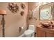 Powder room with a custom sink, decorative flowers, and designer lighting at 4419 Via Bianca Ave, Las Vegas, NV 89141