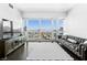 Bright living room features a leather sofa, sleek TV console, and expansive city views at 4471 Dean Martin Dr # 1502, Las Vegas, NV 89103