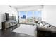 Bright living room features a leather sofa, sleek TV console, and expansive city views at 4471 Dean Martin Dr # 1502, Las Vegas, NV 89103