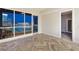 Inviting living room showcasing herringbone-patterned floors, a balcony, and stunning city views at 4575 Dean Martin Dr # 2701, Las Vegas, NV 89103