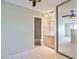 View of the bedroom showcasing a bathroom in the back, tile flooring and a mirrored closet at 4600 University Center Dr # 175, Las Vegas, NV 89119