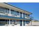 Exterior shot of a two-story apartment featuring a blue balcony and window shutters at 4600 University Center Dr # 175, Las Vegas, NV 89119
