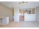 Spacious living area with tile flooring, neutral walls and a partial wall with built-in shelving at 4600 University Center Dr # 175, Las Vegas, NV 89119