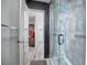 Modern bathroom showcasing a glass shower, wood-look flooring, and a stylish vanity mirror at 4614 Grand Dr # 1, Las Vegas, NV 89169