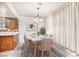 Cozy dining area with a modern chandelier, table set for six, and lots of natural light at 4614 Grand Dr # 1, Las Vegas, NV 89169