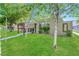Quaint single-story home with a well-maintained lawn, trees, and unique architectural details at 4614 Grand Dr # 1, Las Vegas, NV 89169