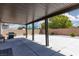 Covered patio with a barbecue grill and desert landscaping at 5136 Stonecrop St, North Las Vegas, NV 89031