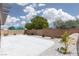 Wide backyard with patio, rock landscaping, and privacy wall at 5136 Stonecrop St, North Las Vegas, NV 89031