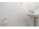 Bathroom featuring modern pedestal sink and neutral tiling at 5136 Stonecrop St, North Las Vegas, NV 89031