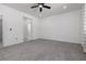 Spacious bedroom with a ceiling fan, neutral carpet and large windows at 5136 Stonecrop St, North Las Vegas, NV 89031
