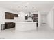 Bright kitchen featuring a spacious island with quartz countertops and stainless steel appliances at 5136 Stonecrop St, North Las Vegas, NV 89031