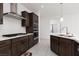 Beautiful kitchen with stainless steel appliances, gray cabinets, and a modern range hood at 5136 Stonecrop St, North Las Vegas, NV 89031