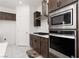 Close up view of the kitchen stainless steel appliances and sleek gray cabinets at 5136 Stonecrop St, North Las Vegas, NV 89031