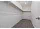 Walk-in closet with carpet flooring, a single light fixture, and shelving at 5136 Stonecrop St, North Las Vegas, NV 89031