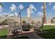 Cozy backyard with a brick-paved fire pit area and artificial turf for outdoor enjoyment at 517 Scenic Terra Dr, Henderson, NV 89015