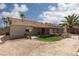 Charming backyard with a covered patio, gravel landscaping, palm trees, and artificial turf at 517 Scenic Terra Dr, Henderson, NV 89015