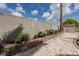 Well-maintained backyard with a block wall, landscaping, and gravel groundcover for low maintenance at 517 Scenic Terra Dr, Henderson, NV 89015
