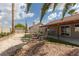 A backyard oasis featuring a covered patio, gravel landscaping, and comfortable seating area at 517 Scenic Terra Dr, Henderson, NV 89015