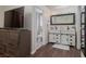 Bathroom featuring a double vanity, walk-in shower, and warm hardwood flooring at 517 Scenic Terra Dr, Henderson, NV 89015