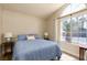 Bright bedroom featuring a large window, blue bedding, and a cozy, inviting atmosphere at 517 Scenic Terra Dr, Henderson, NV 89015
