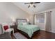 Well-lit bedroom features a cozy bed, chair, nightstands, and serene window view at 517 Scenic Terra Dr, Henderson, NV 89015