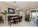 Spacious dining area with a large window offering backyard views, complemented by elegant decor at 517 Scenic Terra Dr, Henderson, NV 89015
