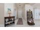 Welcoming entryway with neutral walls, tile floors, console table, decorative shelving and interior door at 517 Scenic Terra Dr, Henderson, NV 89015