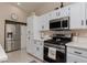 Updated kitchen featuring white cabinets, stainless steel appliances, and modern finishes at 517 Scenic Terra Dr, Henderson, NV 89015
