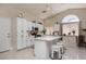 Bright kitchen boasts white cabinets, stainless appliances, and a central island with seating at 517 Scenic Terra Dr, Henderson, NV 89015