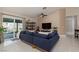 Cozy living room with a large sofa, sliding glass doors to the backyard at 517 Scenic Terra Dr, Henderson, NV 89015