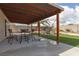 Covered patio with seating, outdoor dining table, and grassy yard at 517 Scenic Terra Dr, Henderson, NV 89015