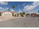 Neighborhood street view showing single-story homes with two car garages, desert landscaping, and a classic terra cotta roofs at 517 Scenic Terra Dr, Henderson, NV 89015