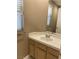 Bathroom featuring a single sink vanity with tile countertops, a large mirror, and a window with blinds at 5201 S Torrey Pines Dr # 1253, Las Vegas, NV 89118