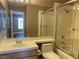 Bathroom featuring a toilet, sink, and shower with glass doors at 5201 S Torrey Pines Dr # 1253, Las Vegas, NV 89118