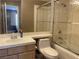 Bathroom featuring shower-tub combo, neutral tile, modern toilet and single sink at 5201 S Torrey Pines Dr # 1253, Las Vegas, NV 89118