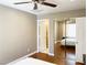 Bedroom with wood floors, ceiling fan and mirror closet in neutral color at 5201 S Torrey Pines Dr # 1253, Las Vegas, NV 89118