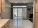 View of the dining area with tile flooring, sliding glass doors to the backyard, and a glimpse of the fireplace at 5201 S Torrey Pines Dr # 1253, Las Vegas, NV 89118