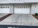 Driveway to two-car garage with white doors at 5201 S Torrey Pines Dr # 1253, Las Vegas, NV 89118