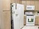 Kitchen with white appliances, light wood cabinets, and tile countertops at 5201 S Torrey Pines Dr # 1253, Las Vegas, NV 89118