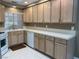 Bright kitchen featuring light wood cabinets, tiled countertops, white appliances, and a window above the sink at 5201 S Torrey Pines Dr # 1253, Las Vegas, NV 89118
