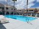 Community pool with lounge chairs at residential building under cloudy sky at 5201 S Torrey Pines Dr # 1253, Las Vegas, NV 89118