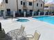 Community pool features jacuzzi with lounge chairs and tables on deck at 5201 S Torrey Pines Dr # 1253, Las Vegas, NV 89118