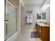 Bathroom featuring a granite vanity, and shower over tub with glass doors at 5250 S Rainbow Blvd # 1084, Las Vegas, NV 89118