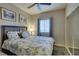 Bedroom features a patterned bedspread, window, and closet with sliding doors at 5250 S Rainbow Blvd # 1084, Las Vegas, NV 89118