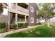 Neutral colored two-story home with a balcony, trimmed bushes, and a well-manicured lawn at 5250 S Rainbow Blvd # 1084, Las Vegas, NV 89118