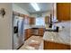 Modern kitchen features stainless steel appliances, granite countertops, and wood cabinets at 5250 S Rainbow Blvd # 1084, Las Vegas, NV 89118