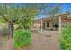 Backyard with covered patio and mature landscaping, providing a tranquil outdoor space at 5373 Painted Mirage Rd, Las Vegas, NV 89149