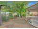 Backyard with covered patio and lush trees providing shade and privacy at 5373 Painted Mirage Rd, Las Vegas, NV 89149