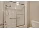 Bathroom shower/tub combination features a sliding glass door and white tile surround at 5373 Painted Mirage Rd, Las Vegas, NV 89149